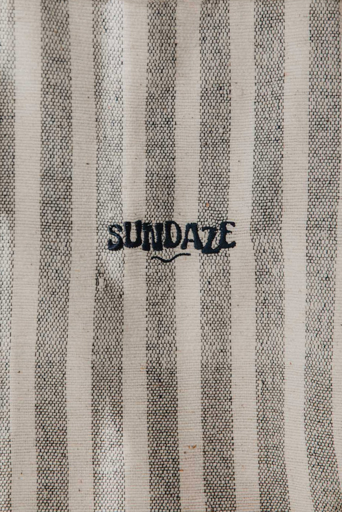 Close-up photo of the striped Chapter One Tote Bag with embroidered SunDaze logo