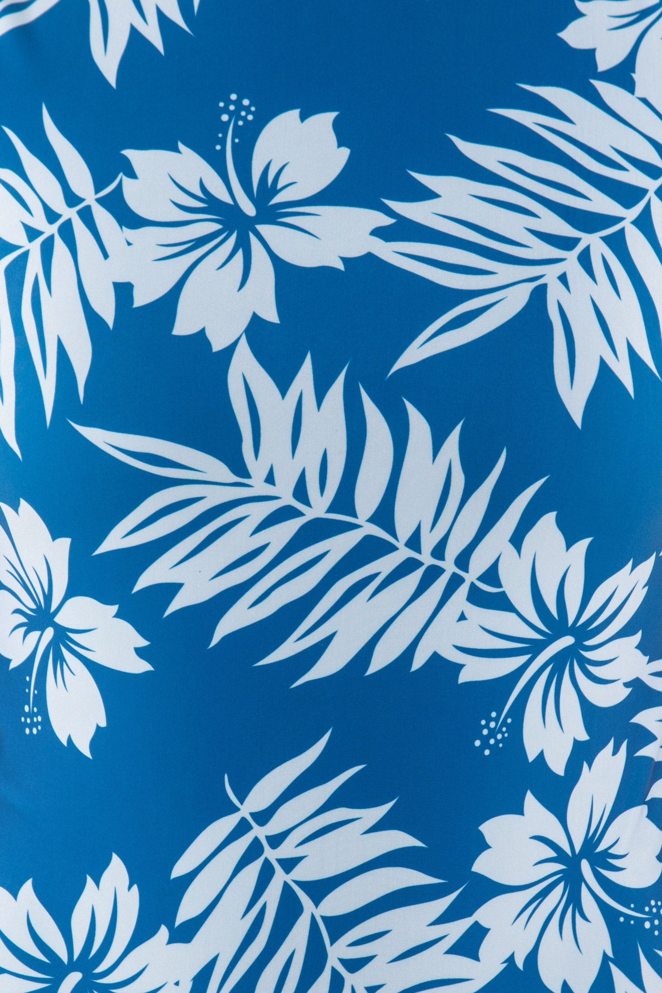 Close-up of the blue and light blue hibiscus print on the Ketut Surf Spring Suit