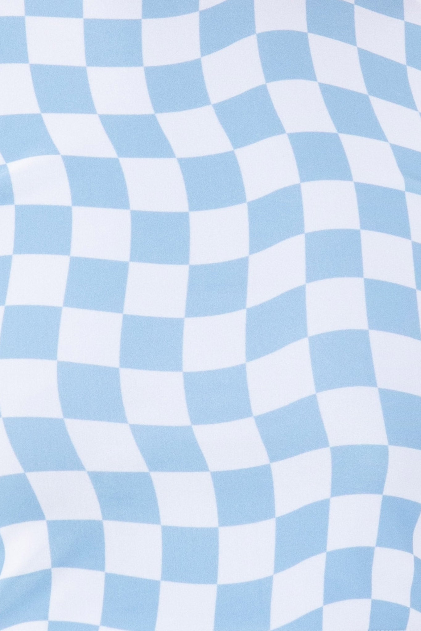 Detailed view of the blue and white checkered fabric of the Putu Triangle Bikini Top