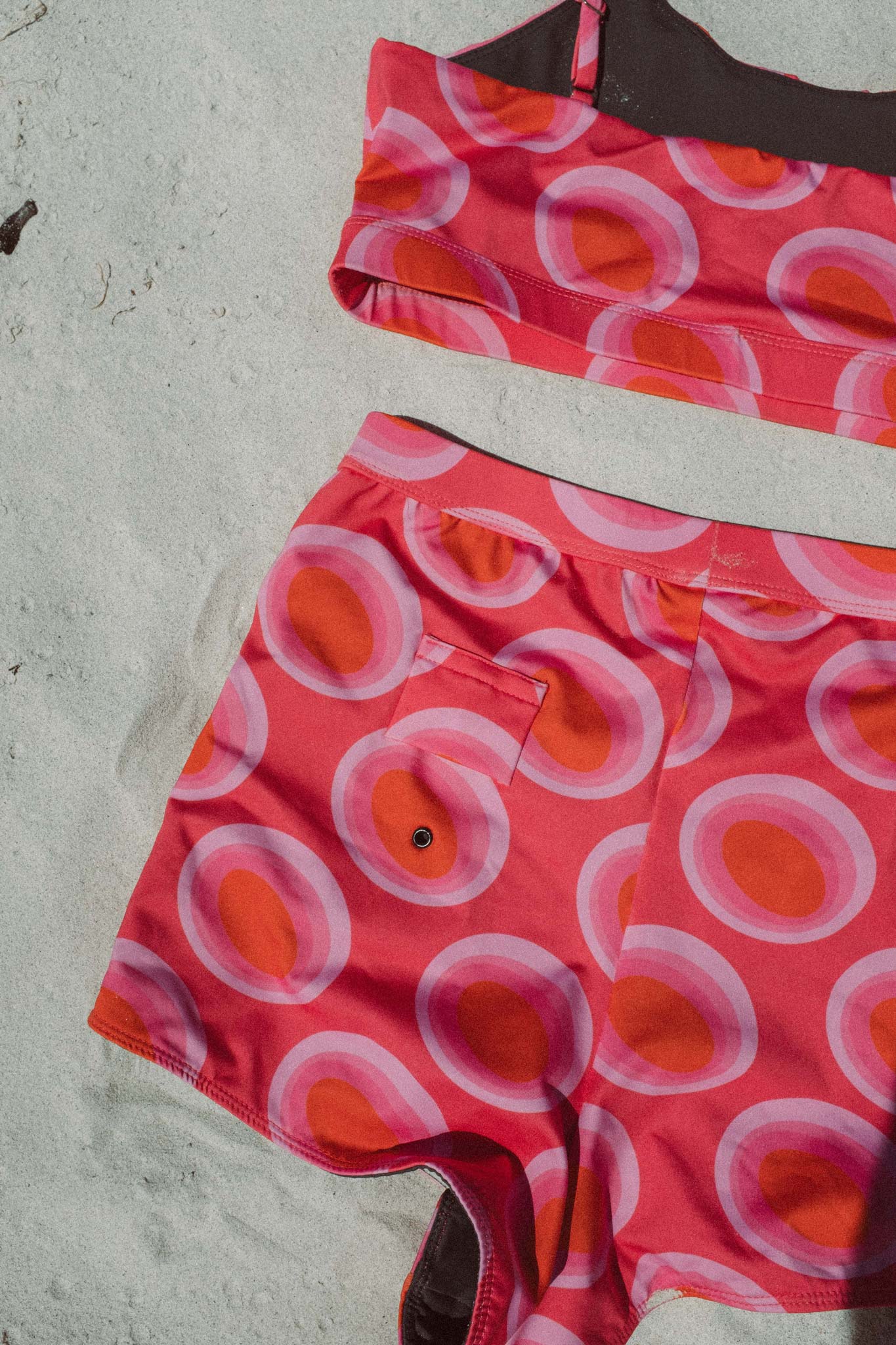 flatlay of the watermelon print surf bikini view from the back on the beach