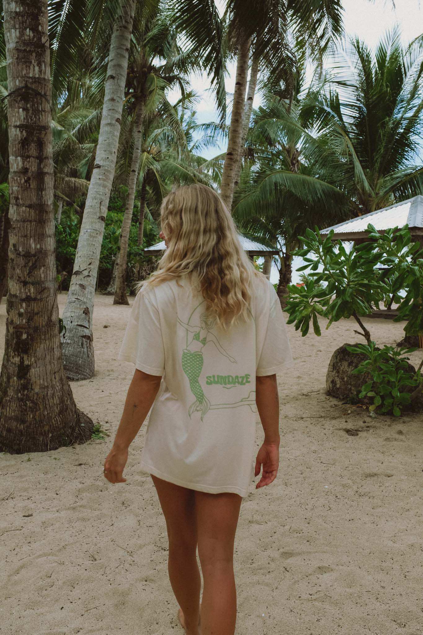 model full body posing from the back showing her t-shirt with mermaid illustration