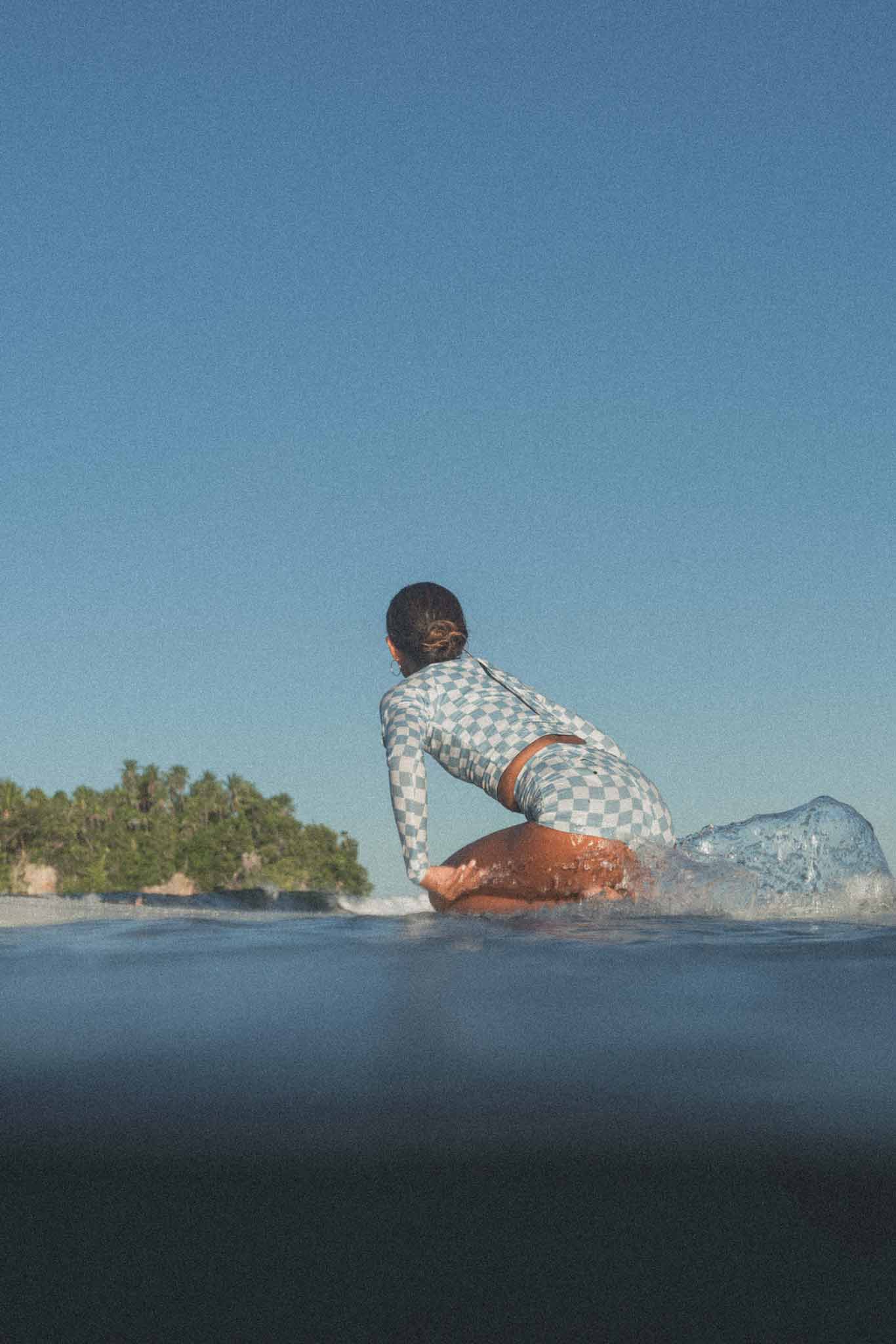 Rear view of the Putu Turtleneck Surf Rashie Top on a model