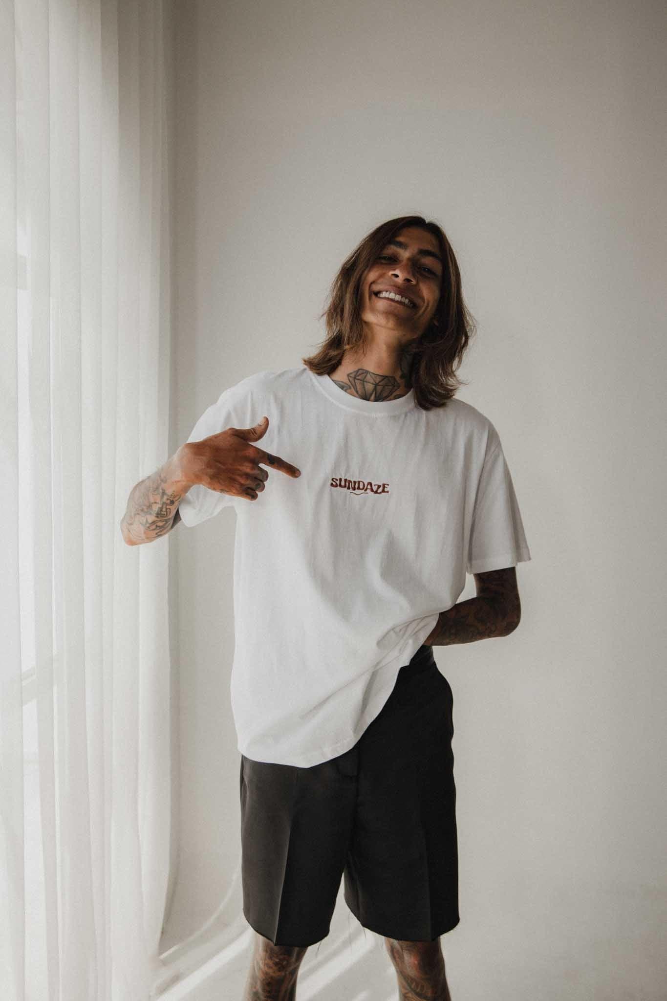 Man in Chapter One Organic Cotton T-Shirt standing by a window